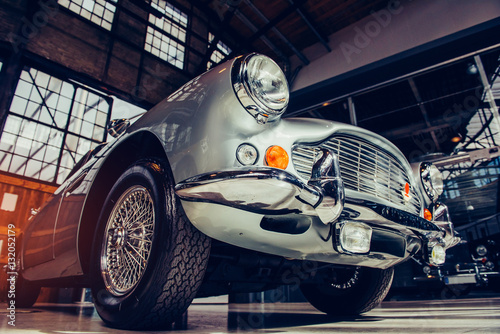 A closeup of the headlights and front bumper on a vintage automo photo