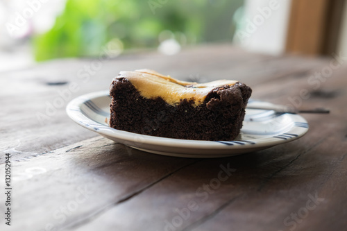 Brownie on wood table with green bokeh background,.Favorite dess