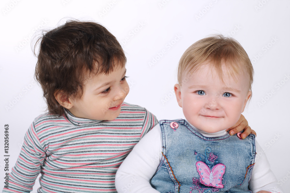two cute hugging children on white two cute hugging children on white