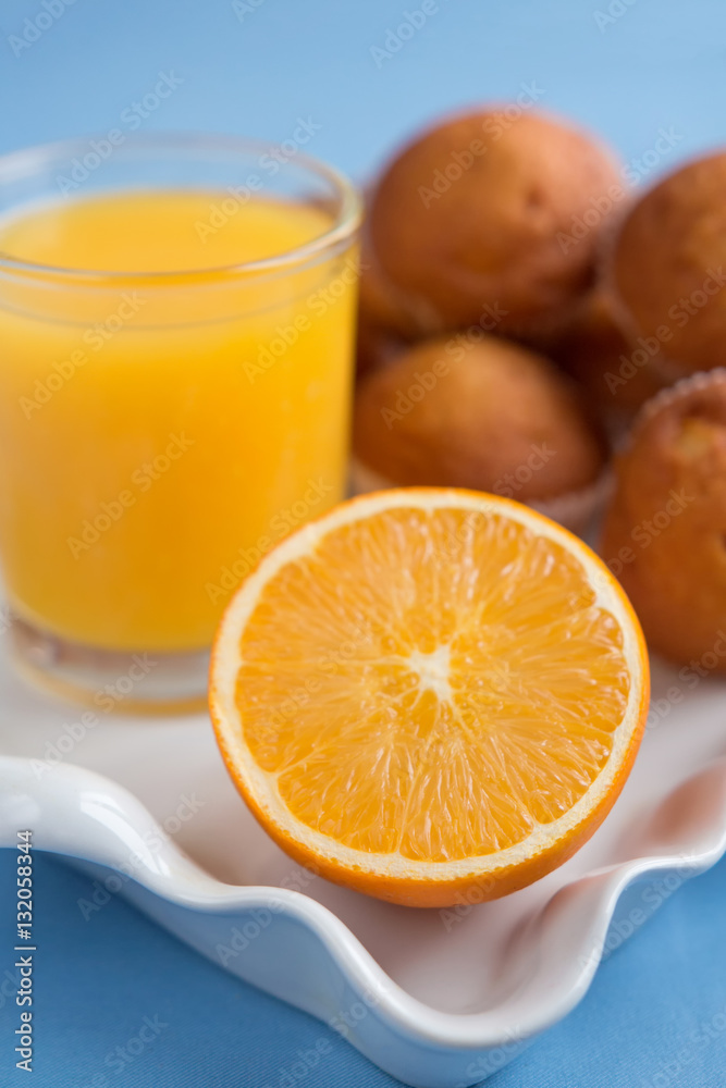 Fresh pastries and orange juice on a light background closeup Fresh pastries and orange juice on a light background closeup
