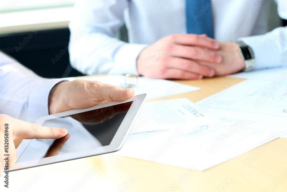 Business colleagues working and analyzing financial figures on a Business colleagues working and analyzing financial figures on a