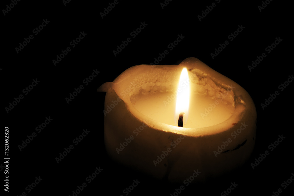 A candle burning in the dark. Hopeful or sad. A candle burning in the dark. Hopeful or sad.