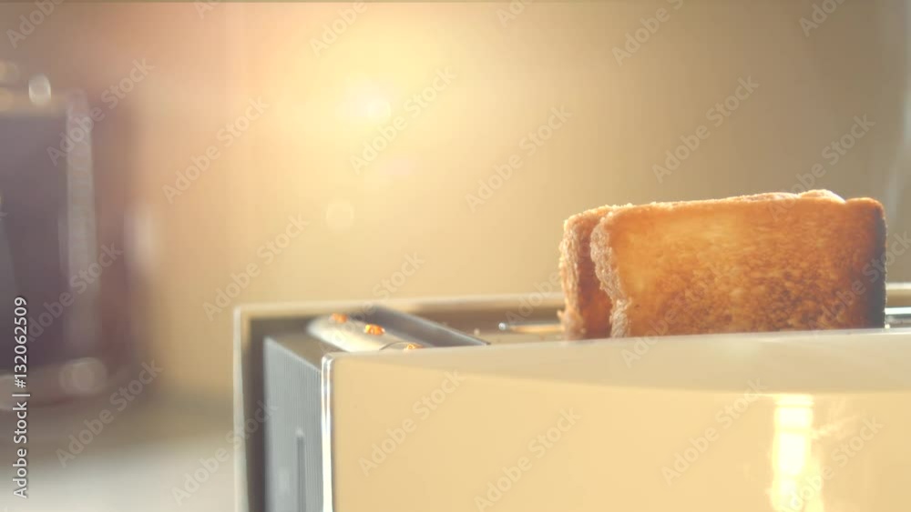 Roasted toast bread popping up from toaster machine with smoke. 4K