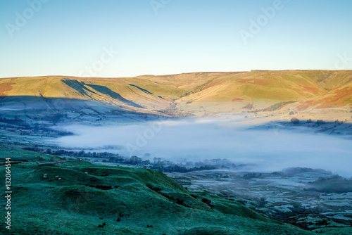  A misty morning sunrise in the middle of winter as viewed from Mam Tor in the Peak District, Hope Valley