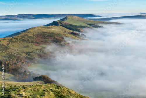 The view across the valley shrouded in mist at the peak of Mam Tor in the Peak District, Hope Valley on a cold winter morning