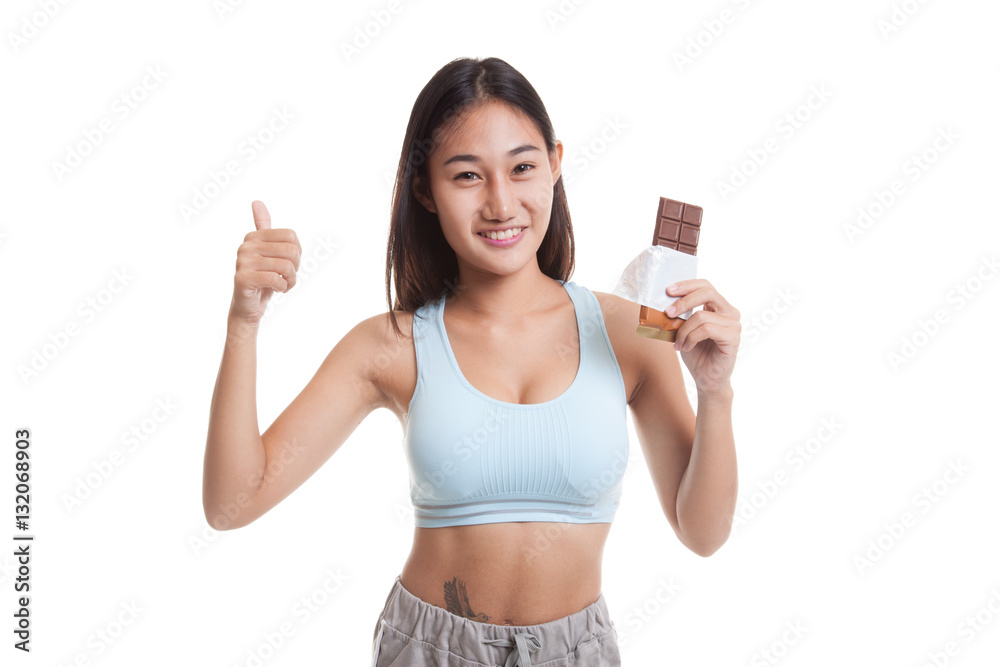 Beautiful healthy Asian girl thumbs up with chocolate. Beautiful healthy Asian girl thumbs up with chocolate.