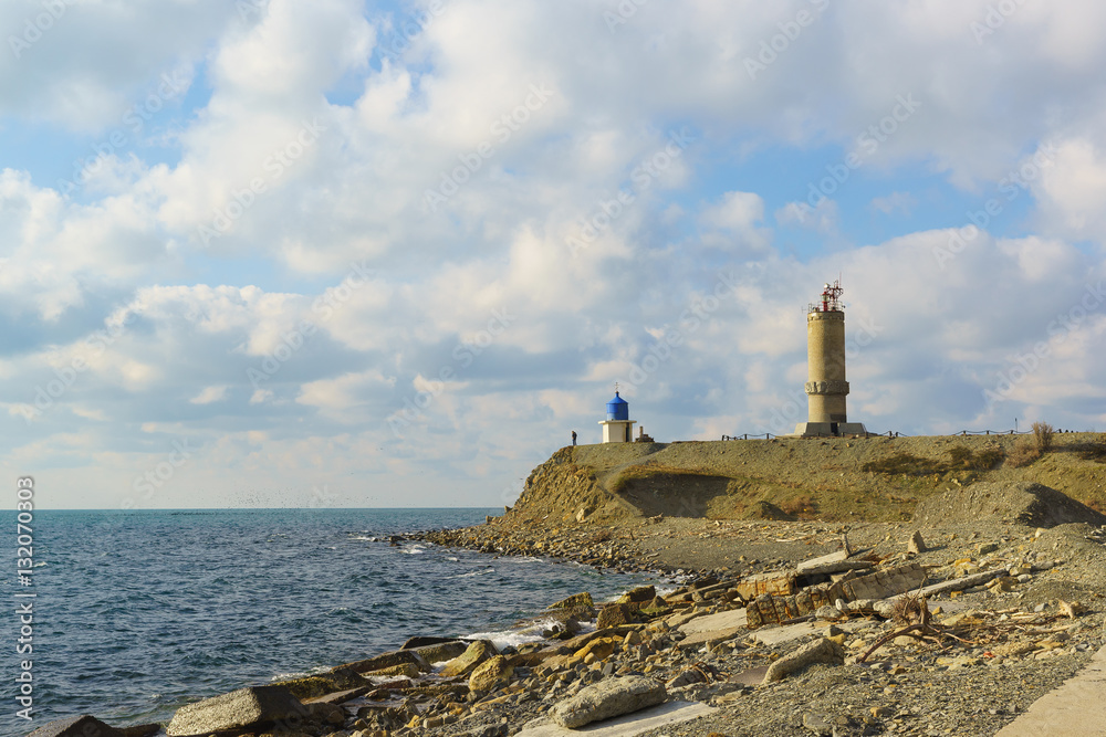 Fototapeta premium The lighthouse at Cape Utrish Dolphinarium in the Black sea. Russia, Krasnodar Krai, village of Big Utrish