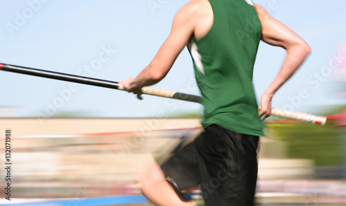 Polevaulter running down the runway (motion blur)