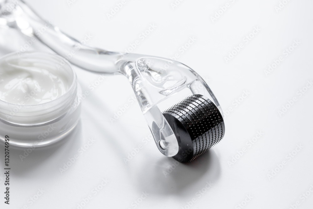 concept beautician desktop with mezoroller - mesotherapy on white background concept beautician desktop with mezoroller - mesotherapy on white background