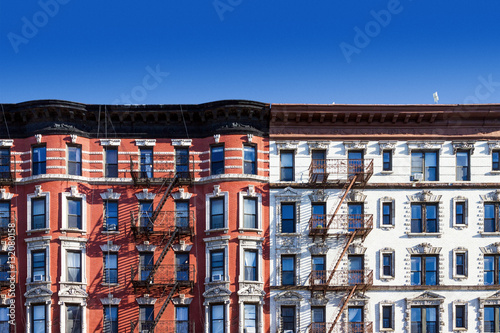 Block of old buildings in New York City with blue sky background photo