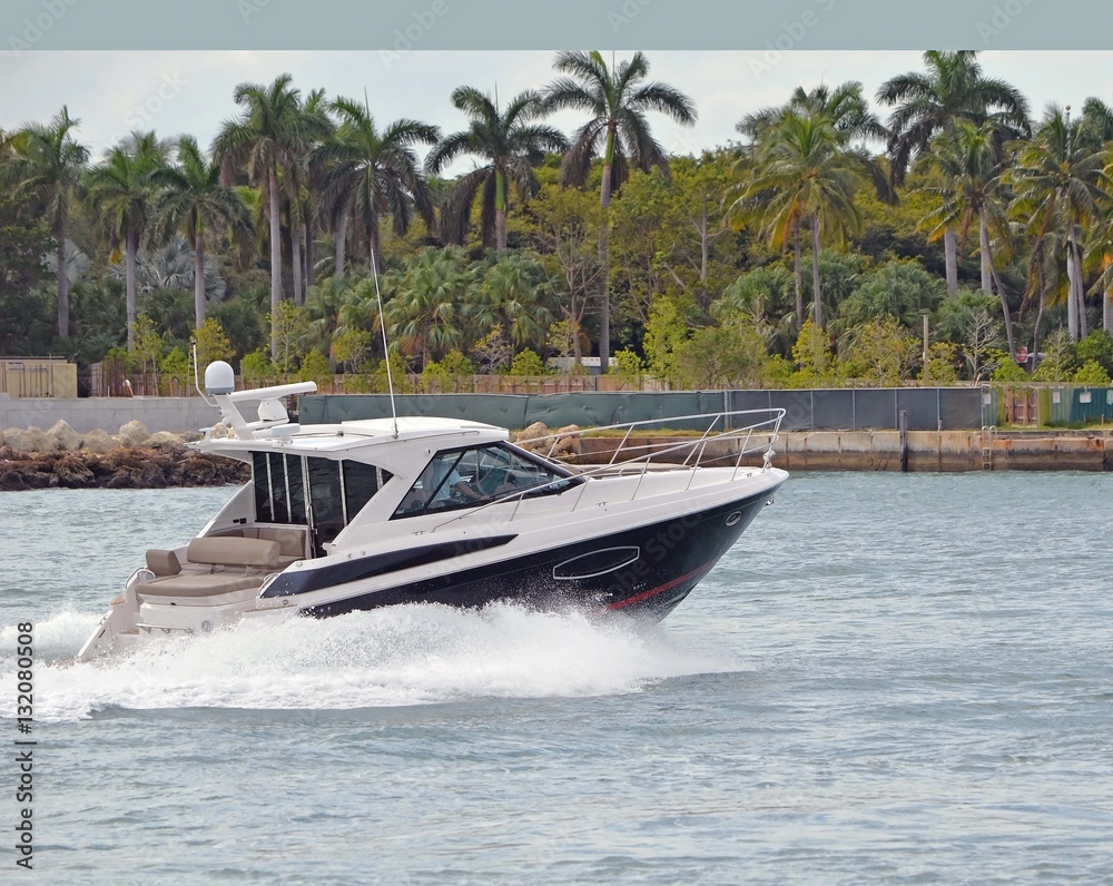 Fototapeta premium An upscale cabin cruiser on Government Cut heading towards the Port of Miami