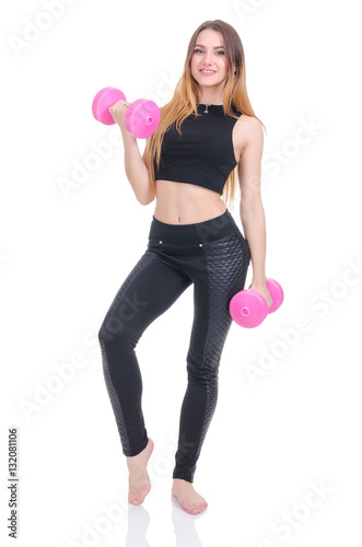 .Diet. Young beautiful girl with pink dumbbells in his hands. Girl performs sporting exercise.