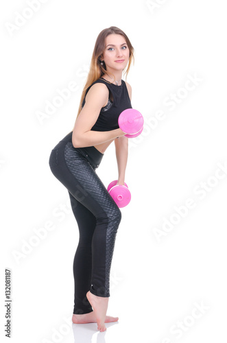.Diet. Young beautiful girl with pink dumbbells in his hands. Girl performs sporting exercise.