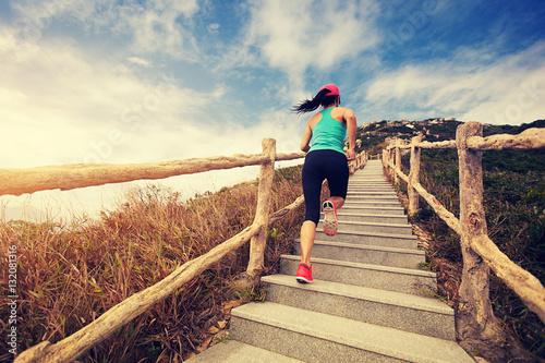 young fitness woman running on mountain stairs