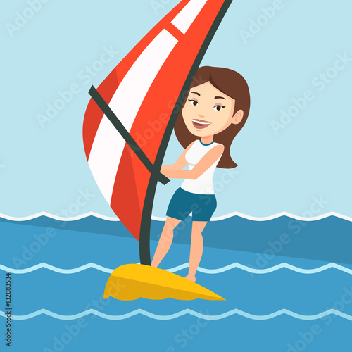 Young woman windsurfing in the sea.