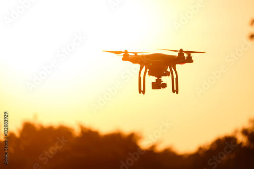Drone silhouette flying in the sunset light beautiful
