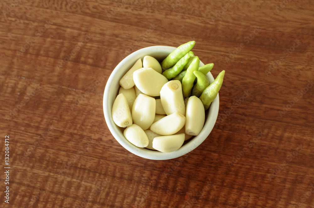 Fresh garlic and chilli in white bowl. Spices. Fresh garlic and chilli in white bowl. Spices.