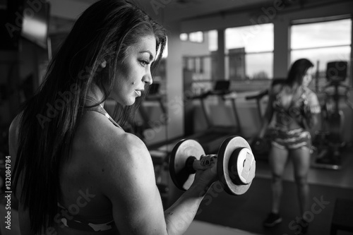 Strong bodybuilder woman curling with barbell in front of mirror © Mat Hayward