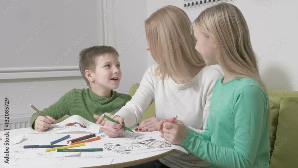 Happy family or Mother with cute children drawing with colorful pencils Happy family or Mother with cute children drawing with colorful pencils
