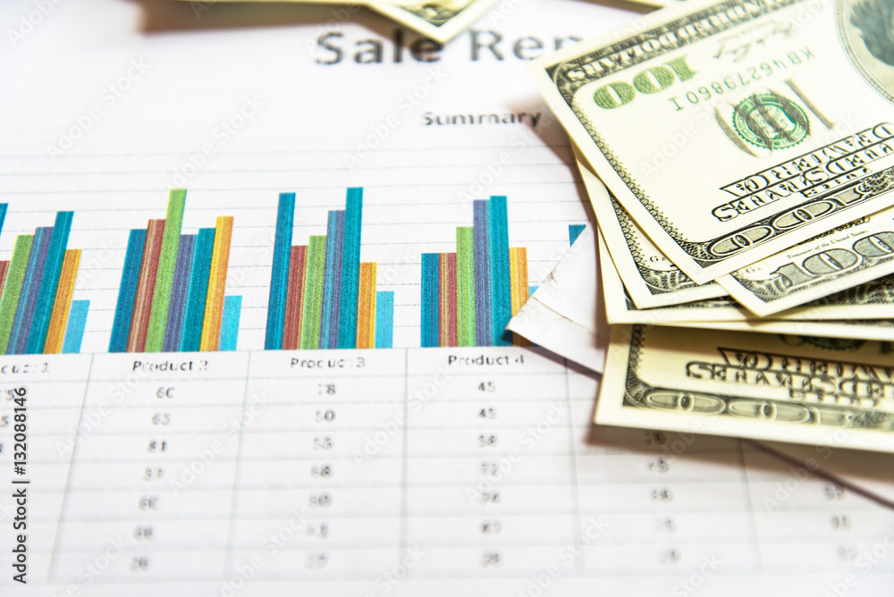 Working place of trader. The table covered by cash notes, keyboard and financial charts. Business financial working. Working place of trader. The table covered by cash notes, keyboard and financial charts. Business financial working.