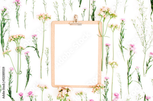 Clipboard mockup and wildflowers pattern. Flat lay, top view