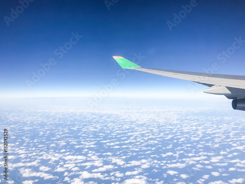Airplane flying above many clouds