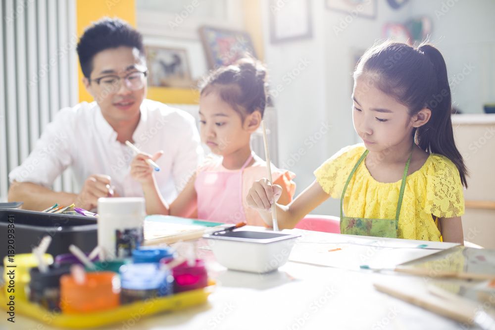 Little children painting in art class with teacher Little children painting in art class with teacher
