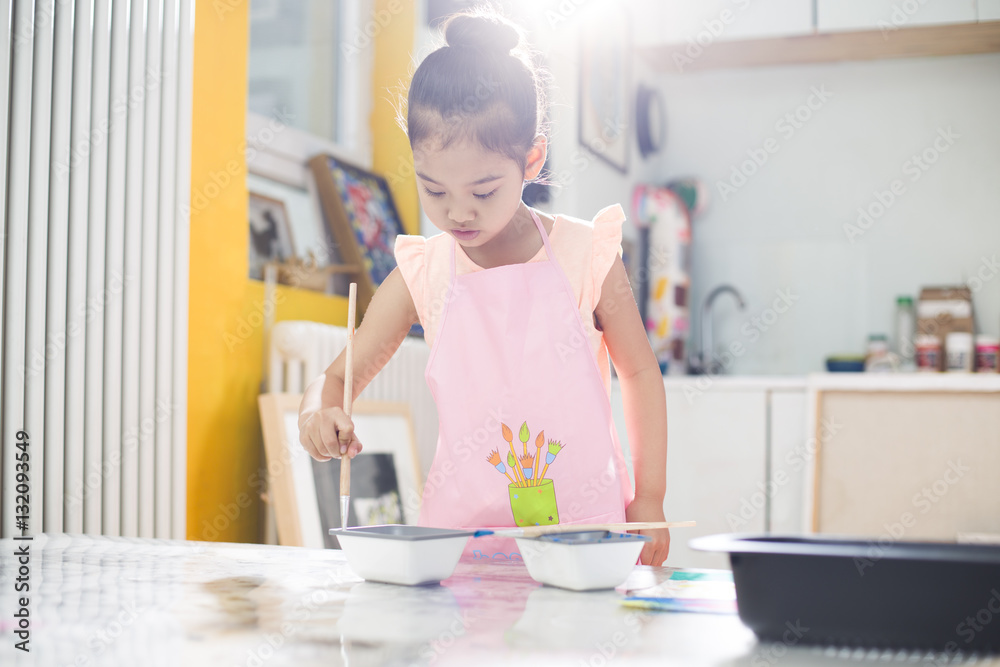 Little girl painting in art class Little girl painting in art class
