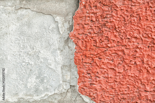 Red, plastered walls with cracks and irregularities photo