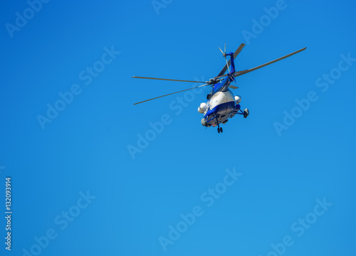 Helicopter flying in the blue sky