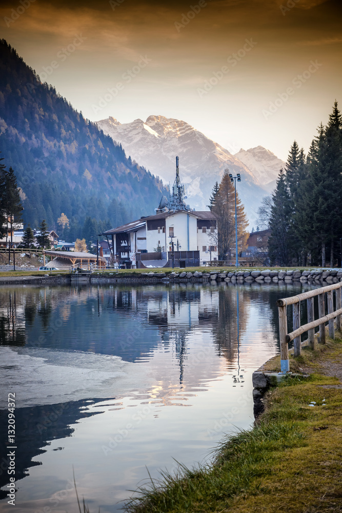Fototapeta premium Sunset in the village in the Alpine mountains. Madonna di Campig