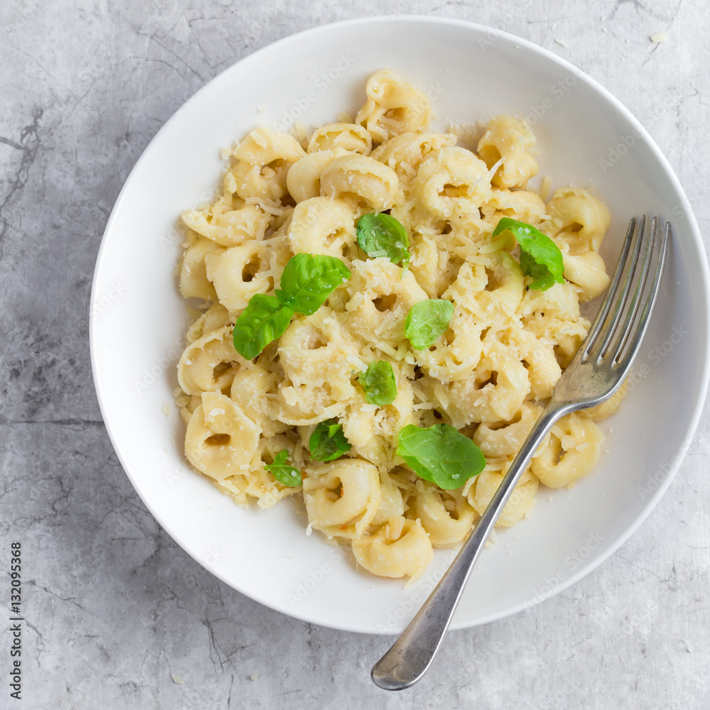 cheese tortellini served with parmesan and basil cheese tortellini served with parmesan and basil