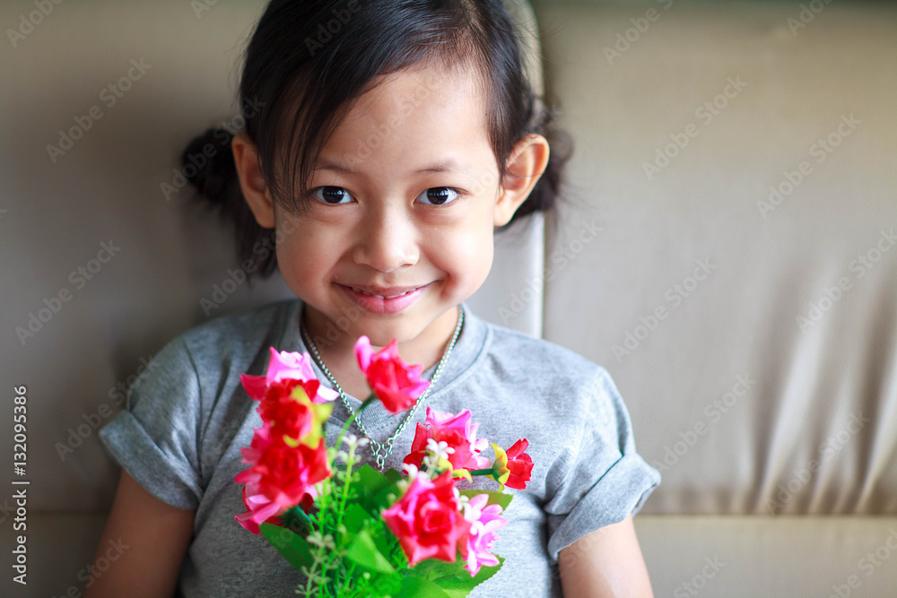 Portrait of a beautiful smile liitle girl and rose,Selective foc Portrait of a beautiful smile liitle girl and rose,Selective foc