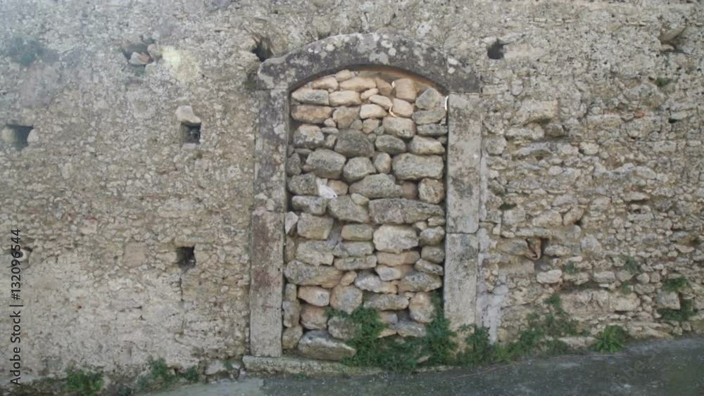 Door filled by some big stones near a wall. Door filled by some big stones near a wall.