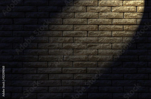 Brick wall textured Wall made of decorative yellow brick as a background. The backlight lamp in the evening.