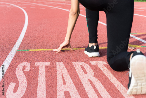 Athlete on starting line waiting for the start in running track