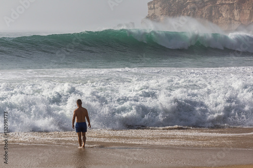 Large ocean waves in Nazare. Autumn day on the Atlantic coast in Portugal. 
