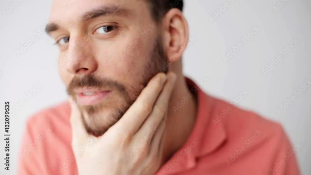 happy young man smartening up in front of camera happy young man smartening up in front of camera