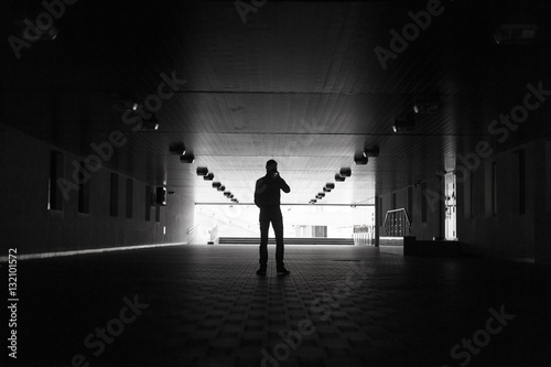 Dark silhouette of a man making an anonymous phone call photo