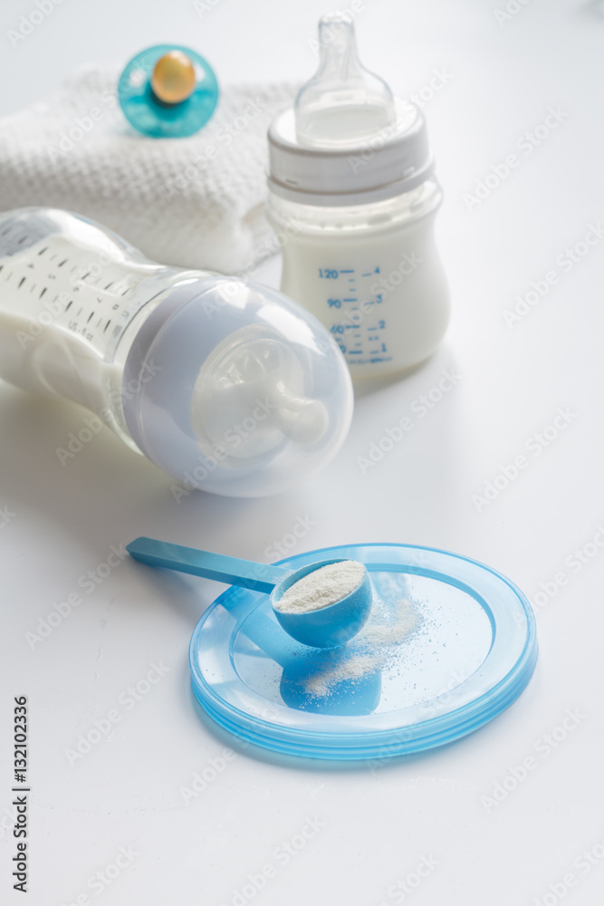 preparation of mixture baby feeding on white background