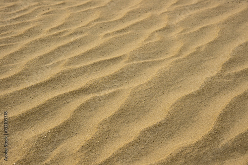 closeup of sand pattern of a beach in the summer © noppharat