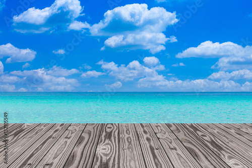 Wood grain deck floor over beautiful sea and sky background