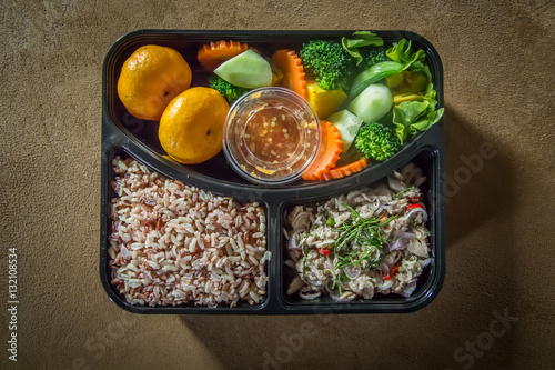 Thai spicy tuna salad with brown rice and vegetables in box