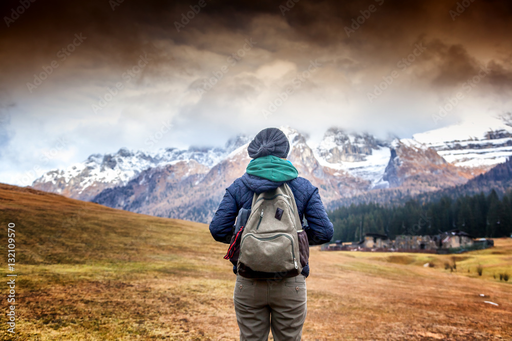 Woman tourist with backpack is back on the background of beautif Woman tourist with backpack is back on the background of beautif