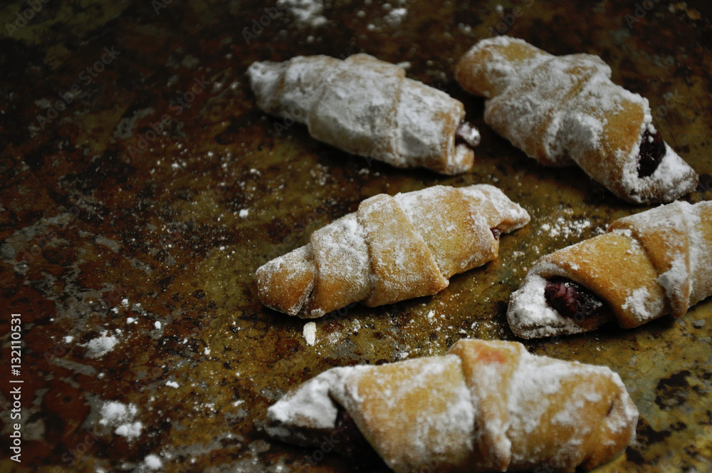 Tasty sweet small croissants on a rustic background