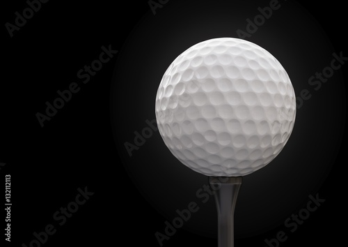 Golf ball on tee on black background.
