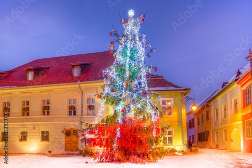 Christmas market and decorations tree in the main center of Sighisoara town, in winter season, Romania