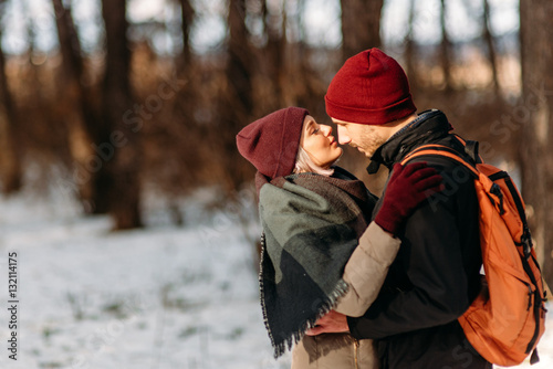 Young hipster couple hugging each other in winter park. © vitleo