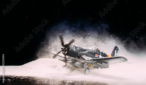 Fotografie World war II military aircraft with heavy snowfall