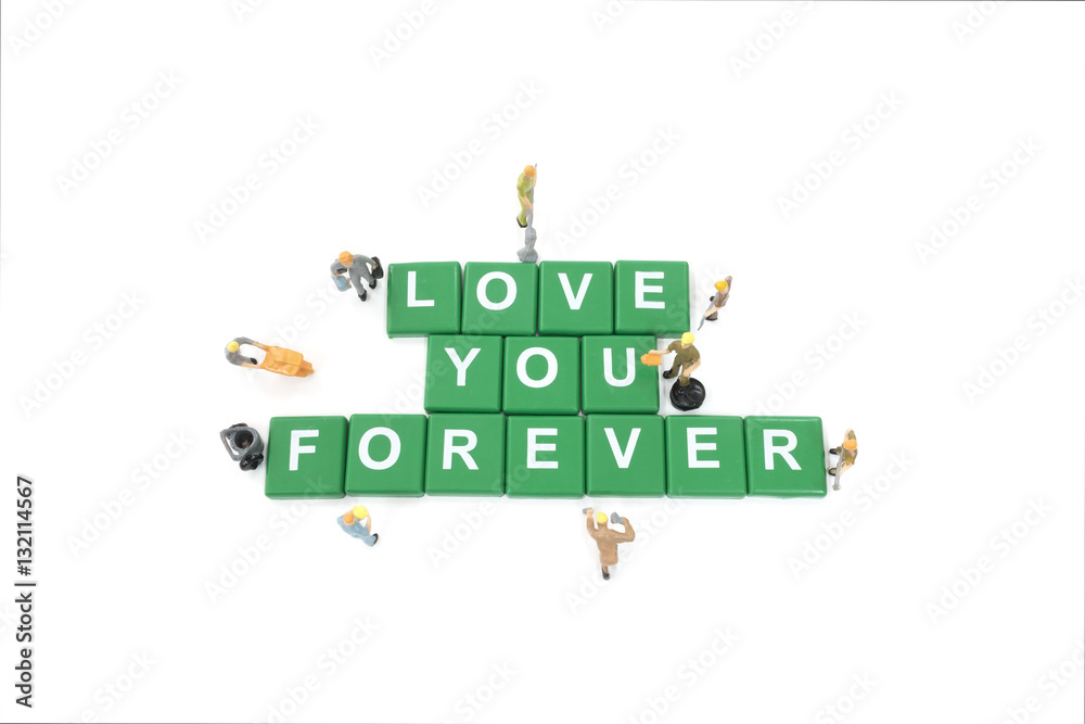 Miniature worker team building word love you forever on white ba Miniature worker team building word love you forever on white ba